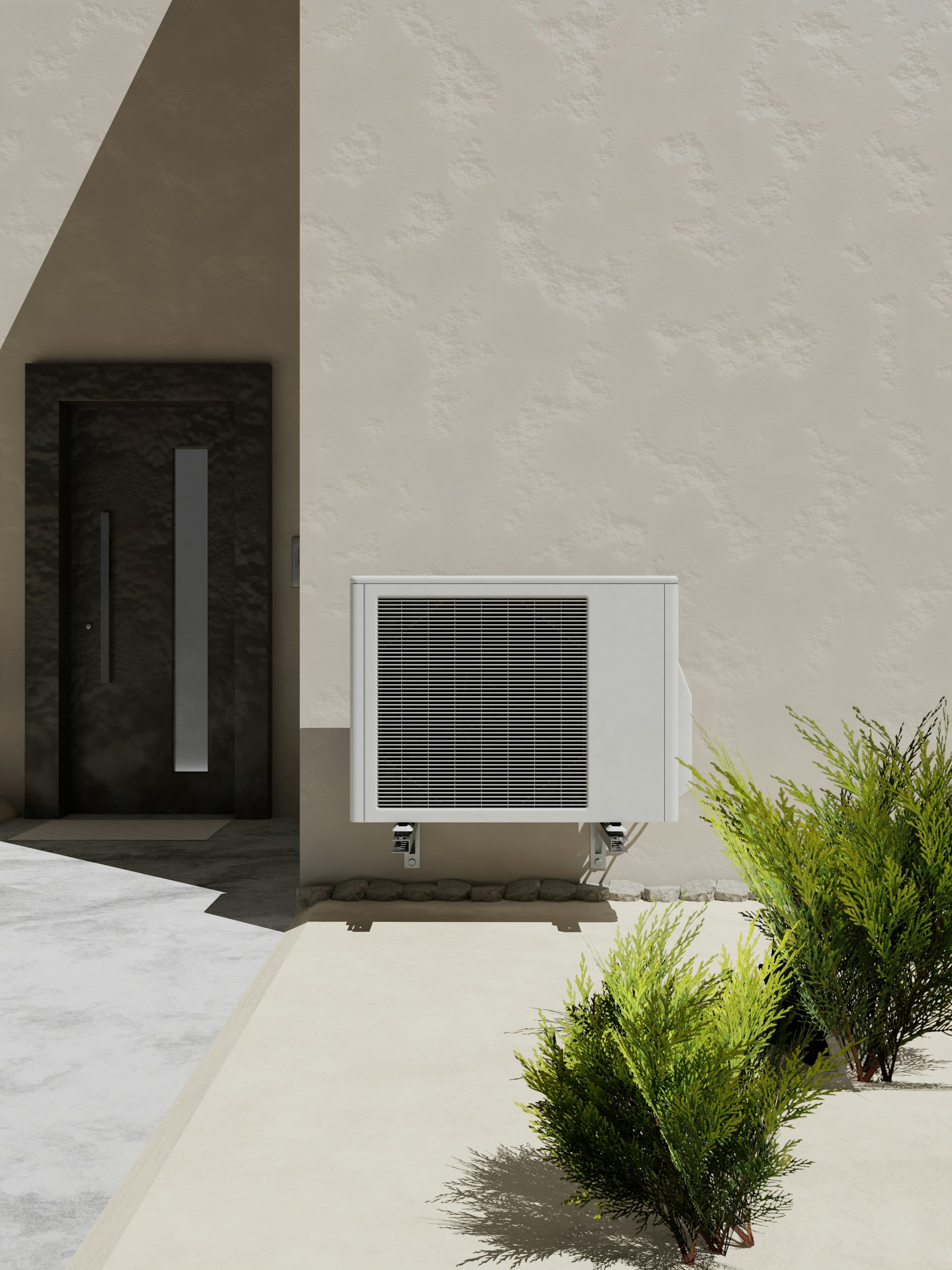 Outdoor HVAC unit placed on a concrete wall, surrounded by plants. The units casing and ventilation grills are clearly visible, with no debris or obstructions around it.